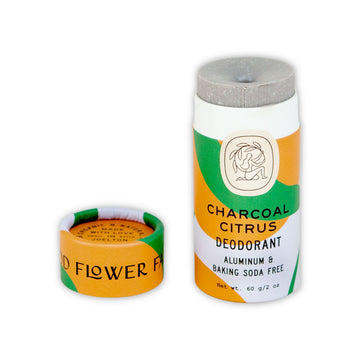Good Flower Farm Charcoal Citrus Deodorant Stick In White, Orange, and Green, Biodegradable Packaging.