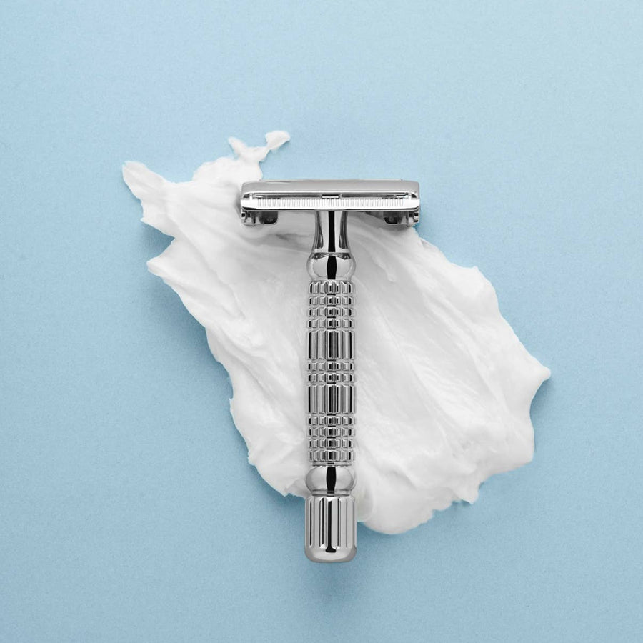 Rockwell Razor, Shown Resting On Shave Cream With Blue Background.