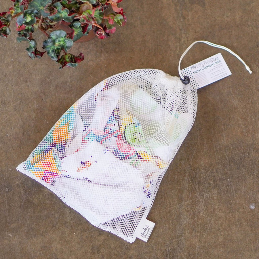 Marleys Monsters Large Mesh Laundry Bag Filled With Laundry Items. Shown Here With A Plant.