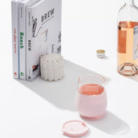W&P Porter Glass In Blush Color With Bottle Of Rose Wine And Books.