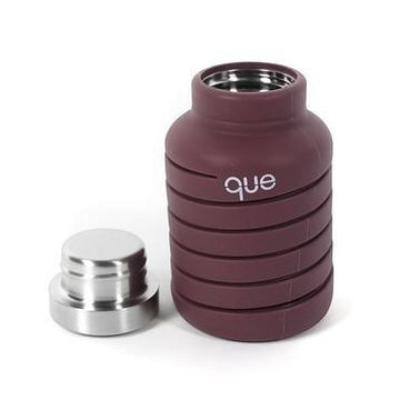 Que Bottle In Frozen Plum Color With Cap. Shown Collapsed For Storage.